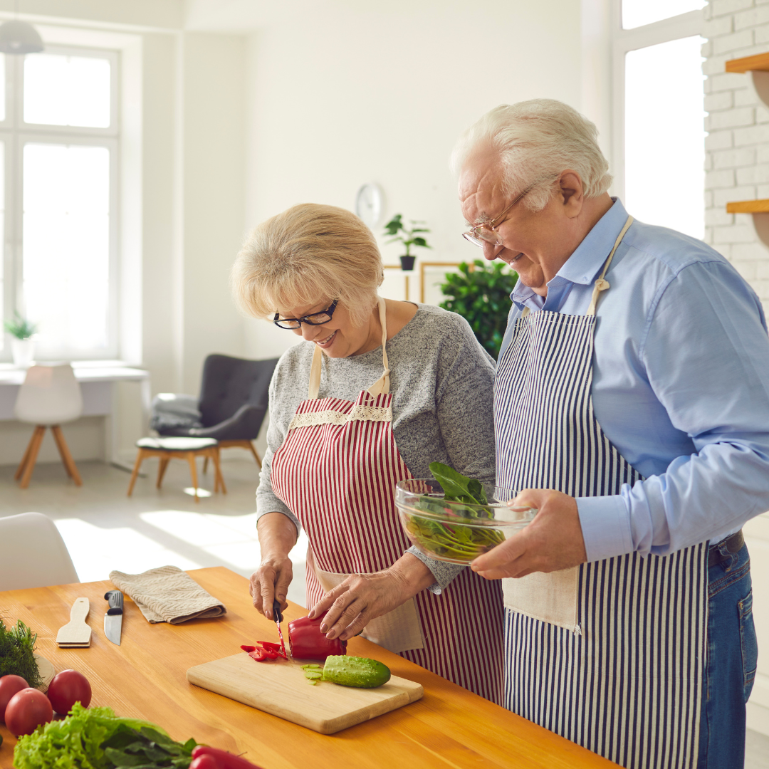 Older couple cooking in kitchen